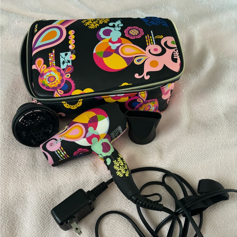 Amika travel size blow dryer with case, concentrator and diffuser attachments.